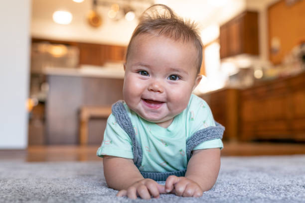 Baby lying on carpet